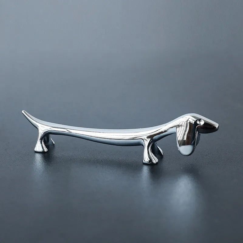 Silver zinc alloy sausage dog chopstick rest on a table