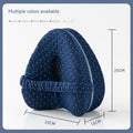 Love heart-shaped dark blue jacquard memory foam leg pillow for adults on a bed.
