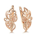 Pair of rose gold hollow carved geometric earrings with rhinestone accents on copper base