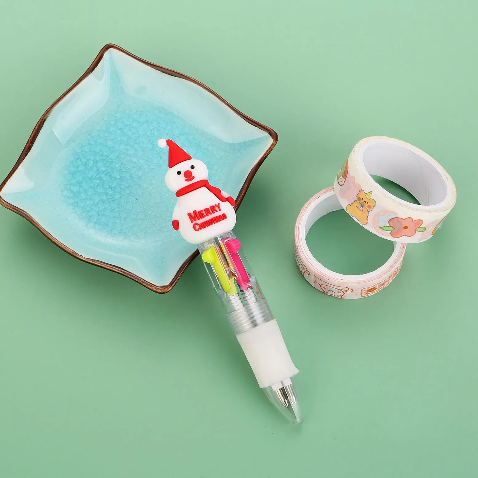 11cm long Christmas-themed four-colour ballpoint pen showing festive designs like reindeer and trees.