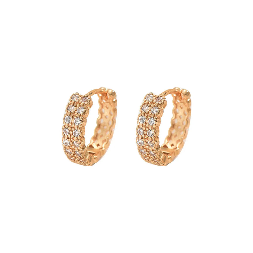 A pair of geometric pattern copper ear studs with round, dot, and ring design details.
