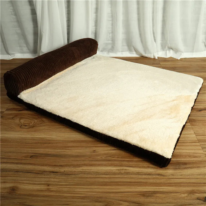 Corduroy pet sofa dog bed with bolster sides, shown in grey colour on a wooden floor