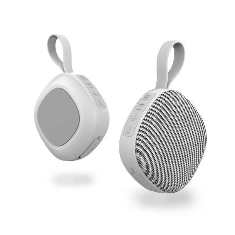 Wireless Bluetooth mini speaker with fabric waterproof cover and magnetic suction, available in black or white shell with grey or green cloth net