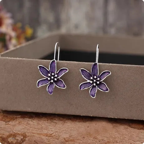 Pair of purple retro-style flower-shaped alloy earrings for women.