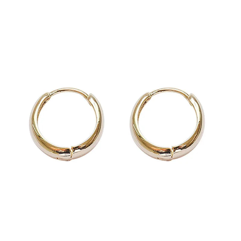 Women's minimalist copper water drop earrings in gold and silver, shown in small, medium, and large sizes.