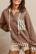 Straw yellow hoodie with striped patchwork design, waffle texture, button neck, and drawstring hood.