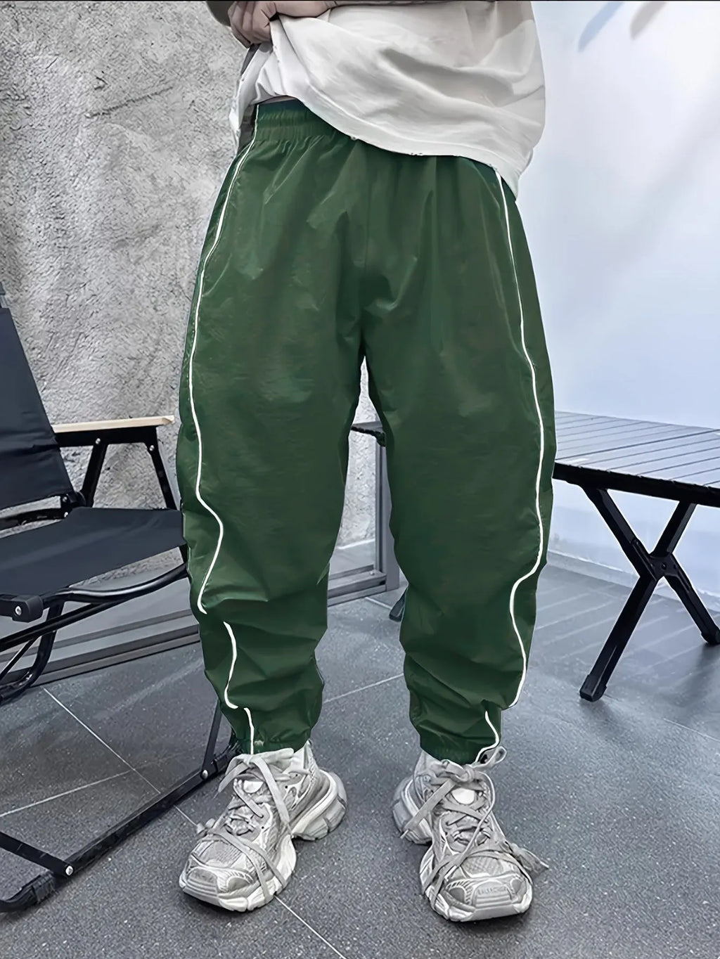 Man wearing blue cropped bamboo fibre sports trousers with a loose, elasticated fit.