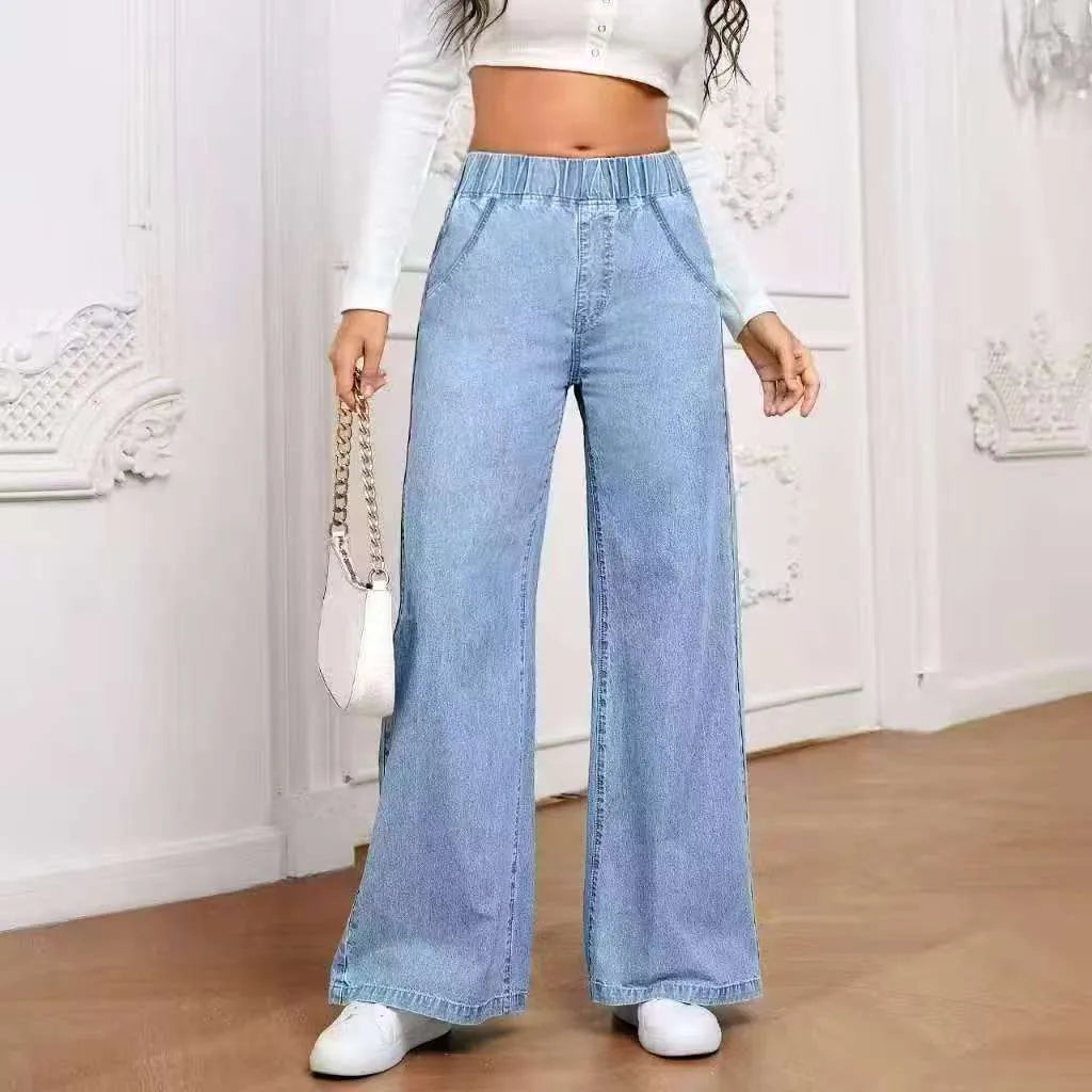 Light blue washed wide-leg denim jeans on a plus-size model, showing straight leg and mid-rise waist.