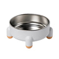 Green high-footed non-slip stainless steel bowl for dogs and cats on a floor.