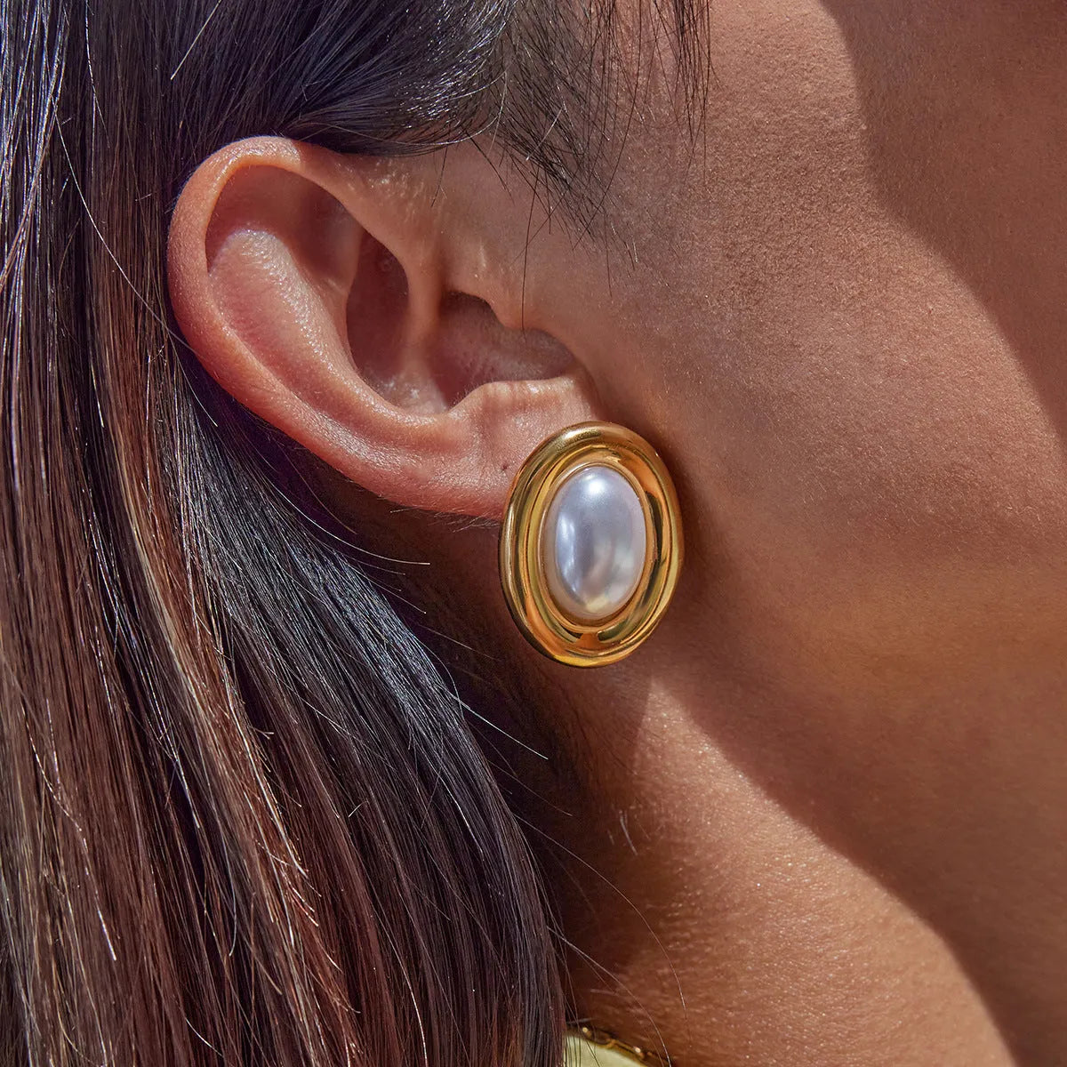 Close-up of stainless steel vintage pearl ear studs for women with a non-fade electroplated finish.