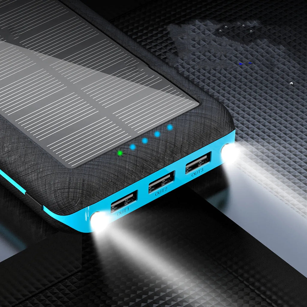 Black wireless power bank with Qi charging pad, three USB ports, and LED flashlight showing capacity display.