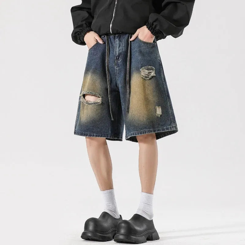 Men's retro blue loose-fit ripped jeans made from cotton denim, shown in a street style.