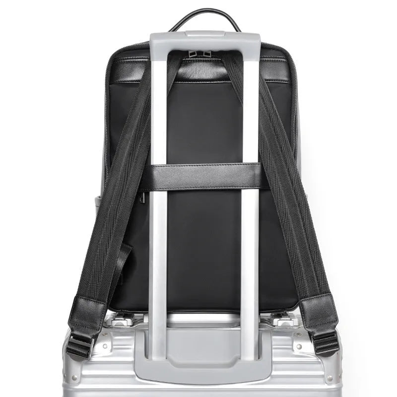Men's black leather computer backpack showing front view with woven design elements