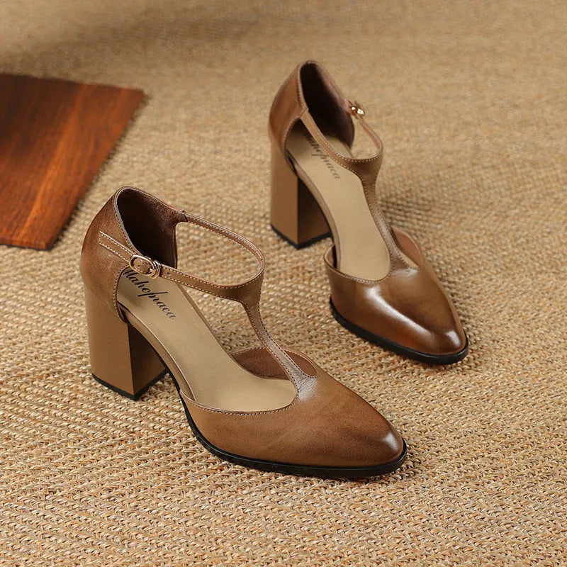 Women's dark brown retro pointed Mary Jane shoes with a hollow toe design and a buckle fastening.