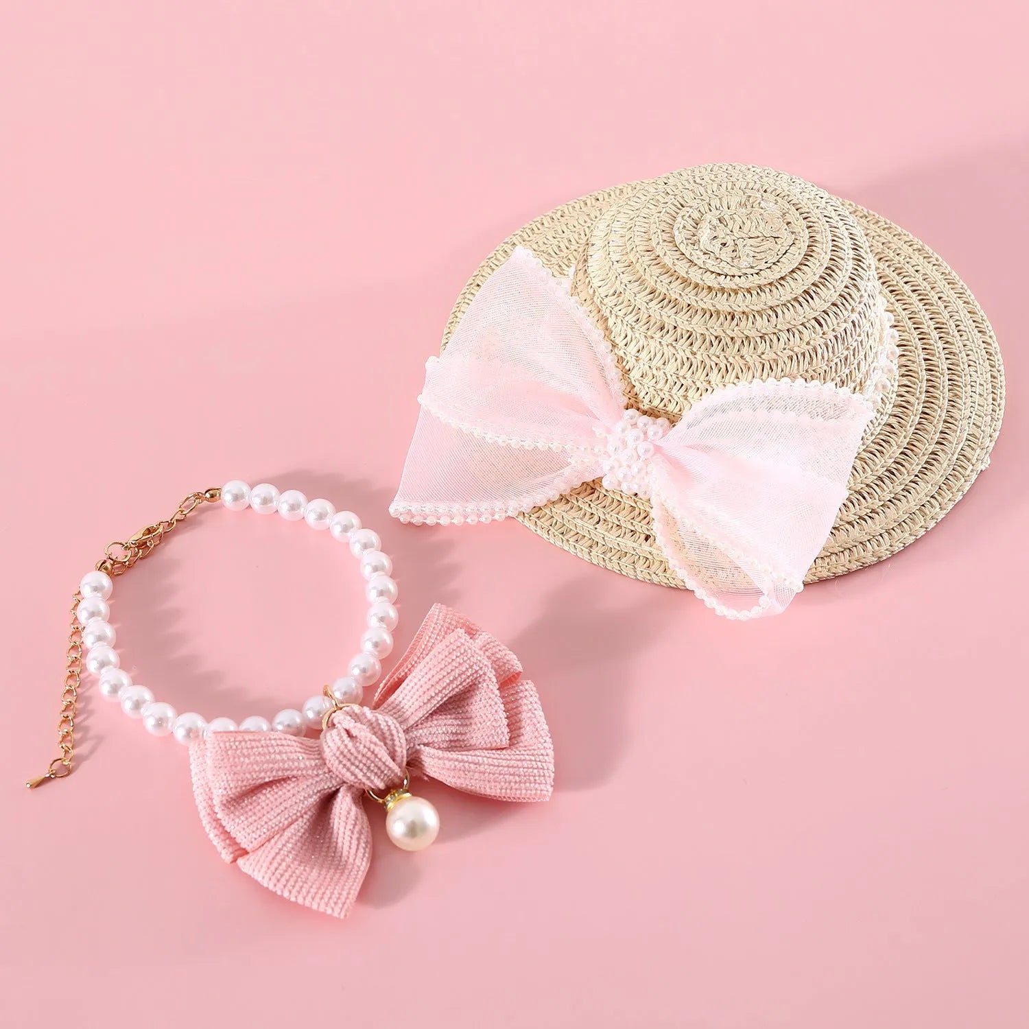 Woven Lafite leaf cat hat with pearl butterfly bow on a pink background, showing S and M size options.