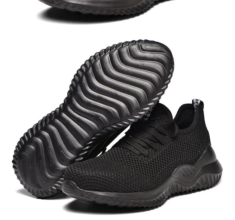 Black low-cut work safety shoes with a visible steel toe cap and textured EVA sole.