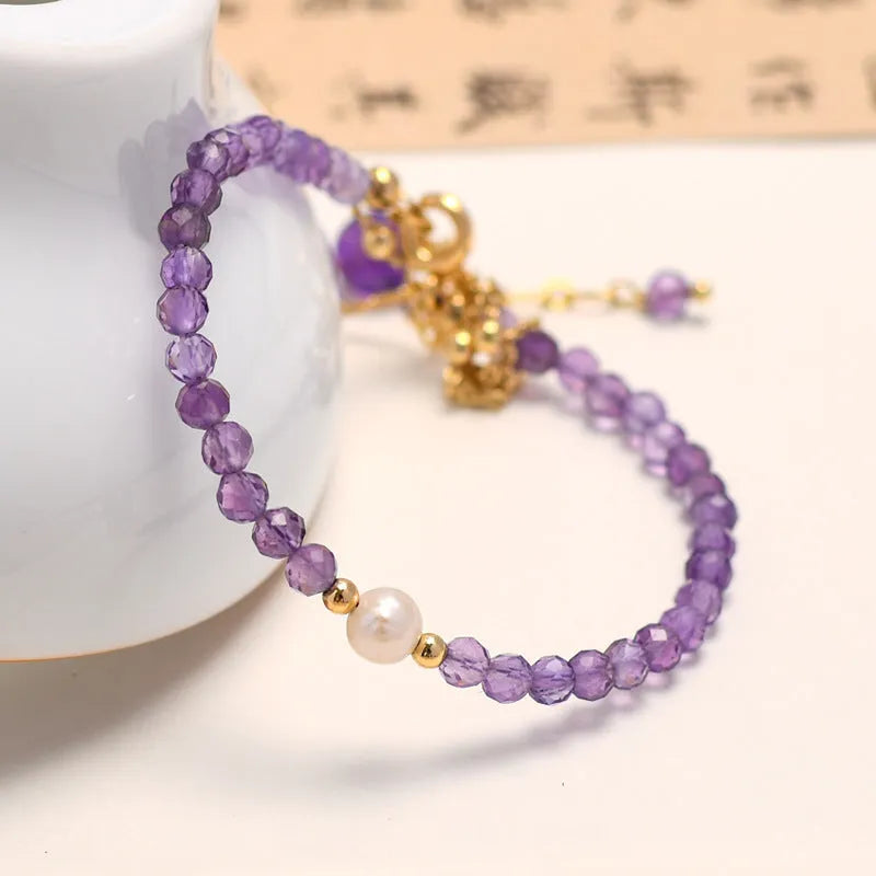 Women's amethyst bracelet with electroplated crystal stones in a diamond Chinese pattern.
