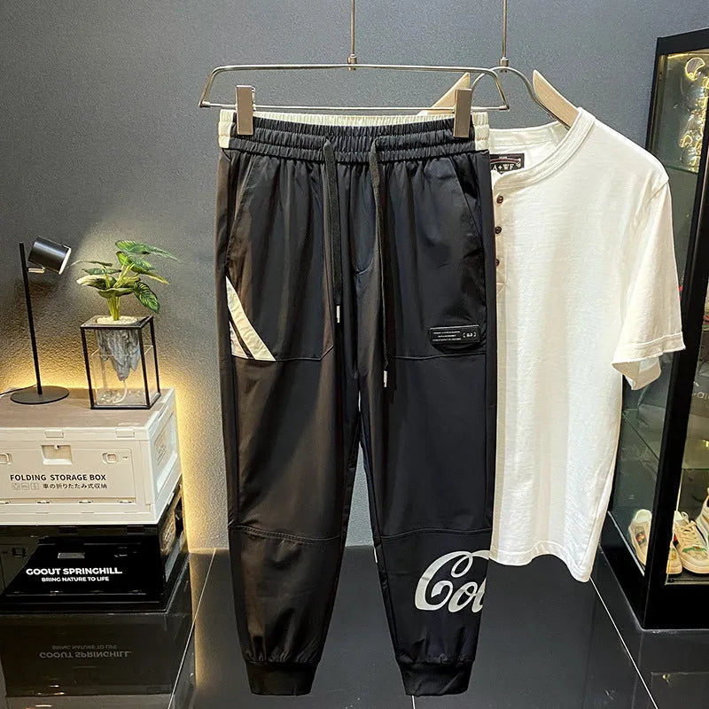 Man wearing black ultra-thin ice silk cropped trousers with elasticated ankle bands.