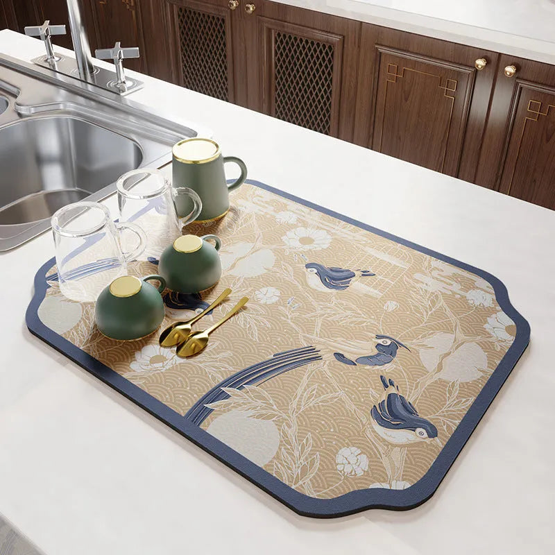 Square diatomite kitchen draining mat in camellia purple on a kitchen worktop, with a teacup resting on it