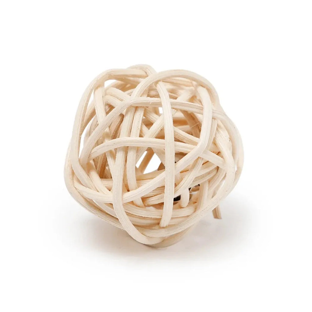 Two cat toys: a faux feather bell ball and a hollow rattan ball on a plain background.