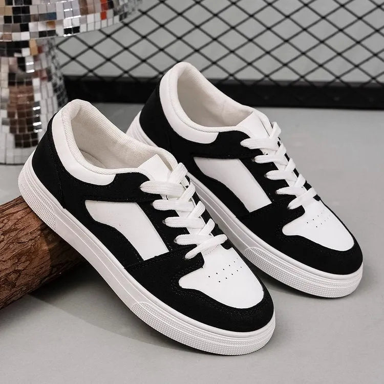 Black women's casual sports shoes with round toe and lace-up front, featuring a low top and flat rubber sole.