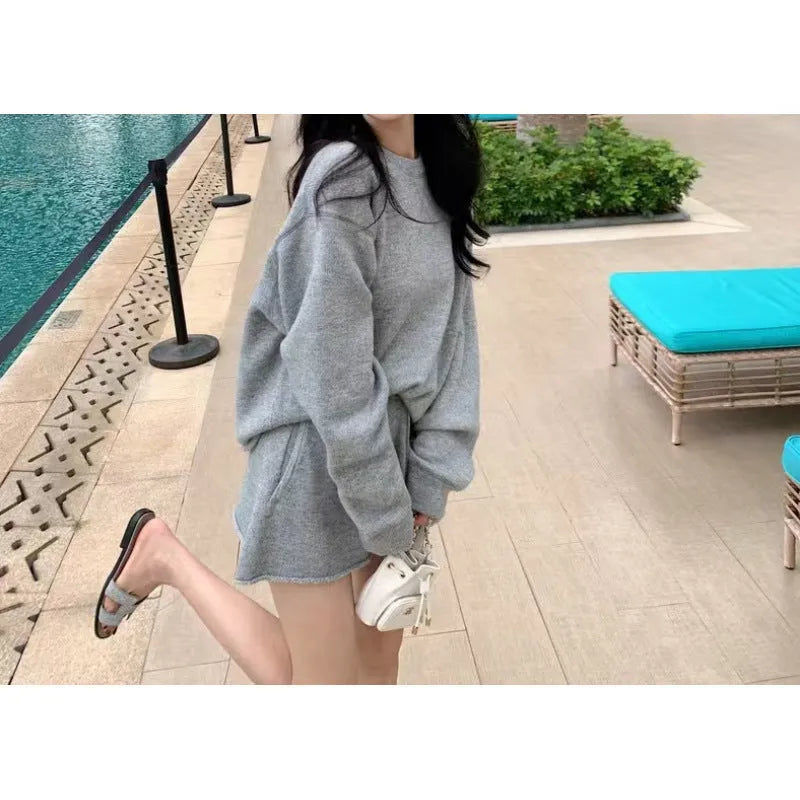 Women's loose-fitting long sleeve sweater and wide-leg shorts two-piece set in a neutral colour.