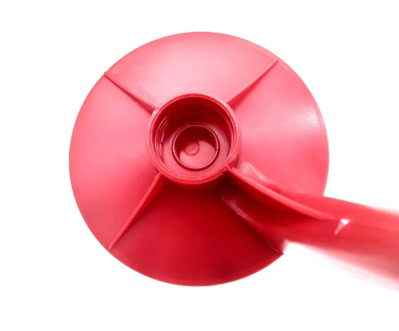 Red plastic Magic Tap soda dispenser screwed onto a 2-litre bottle with push-in tap