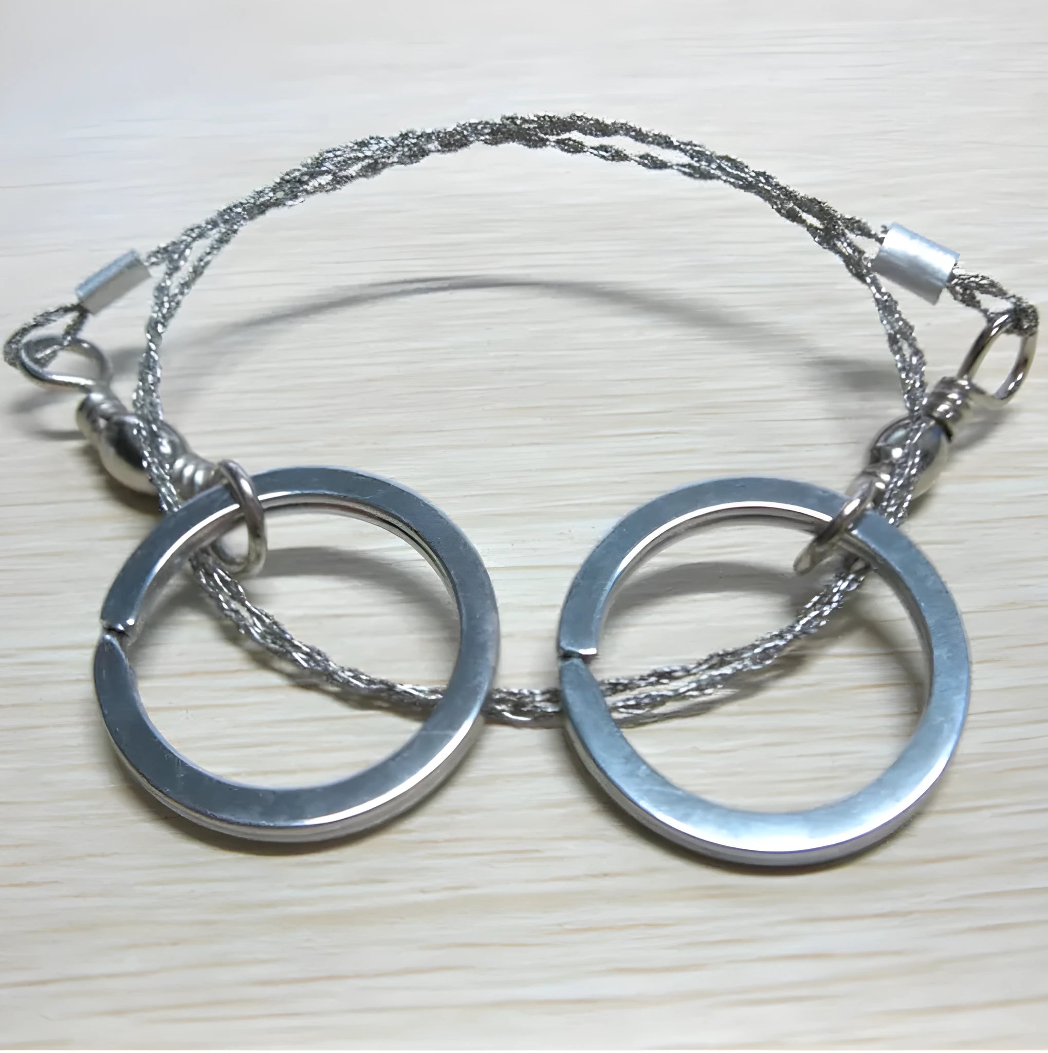 Multifunctional survival wire saw with stainless steel cutting wire and metal pull rings extended to full length