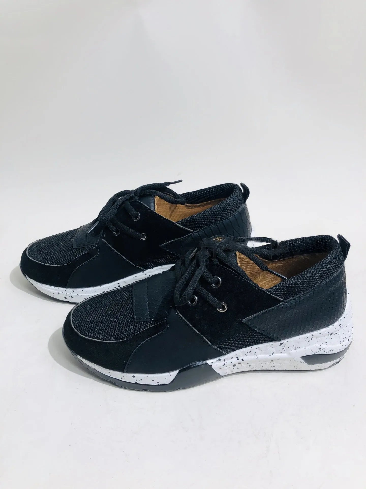 Women's black suede casual sneakers with a wedge heel and round toe on a white background.