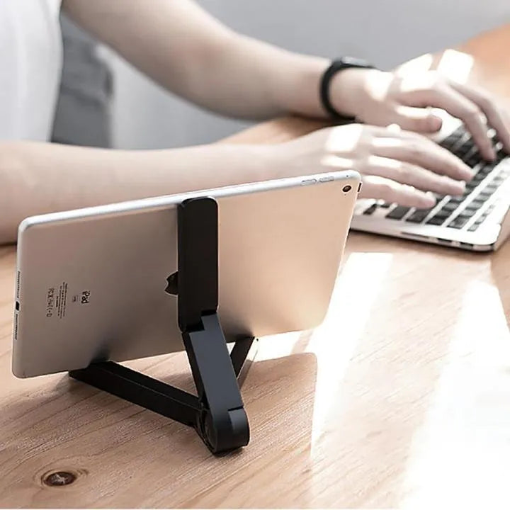 Foldable tablet holder in black showing both folded flat and opened positions with smartphone mounted