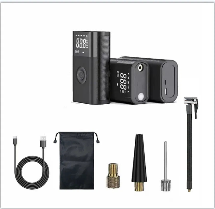 Handheld wireless digital tyre inflator with display screen, LED light, and multiple nozzle adaptors on a table.