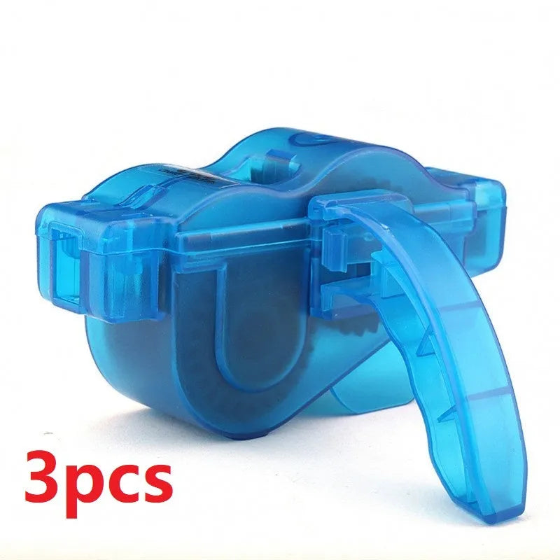 Blue plastic bicycle chain cleaning washer set with brushes on a bike chain