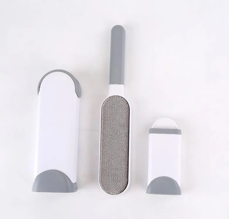 Blue reusable pet hair removal comb with double-sided brush next to its self-cleaning base.