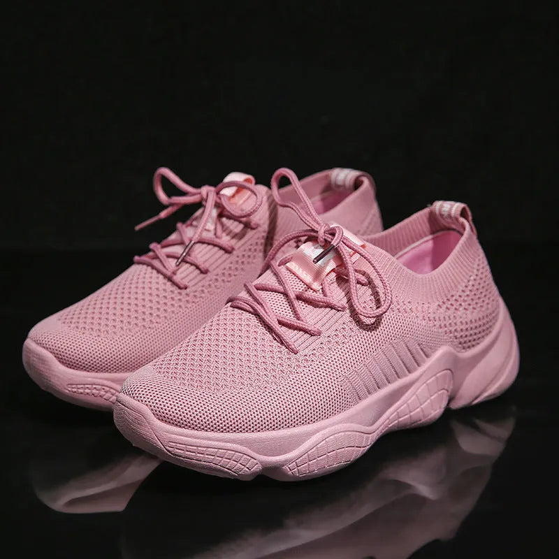 Women's white woven sports shoes with thick rubber sole and front strap.