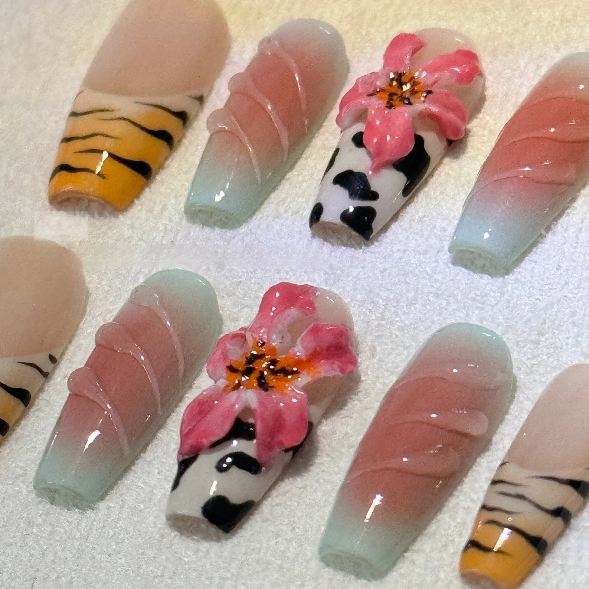 Zebra pattern hand carving nail art with embossed flower and leopard print designs in four sizes
