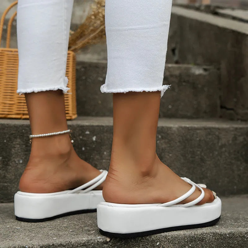 Thick bottom flip flops in white, yellow, black, rose, green, or blue with a round toe and rubber sole.