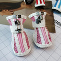 Set of four blue cloth dog shoes with side zips for small breed pets.