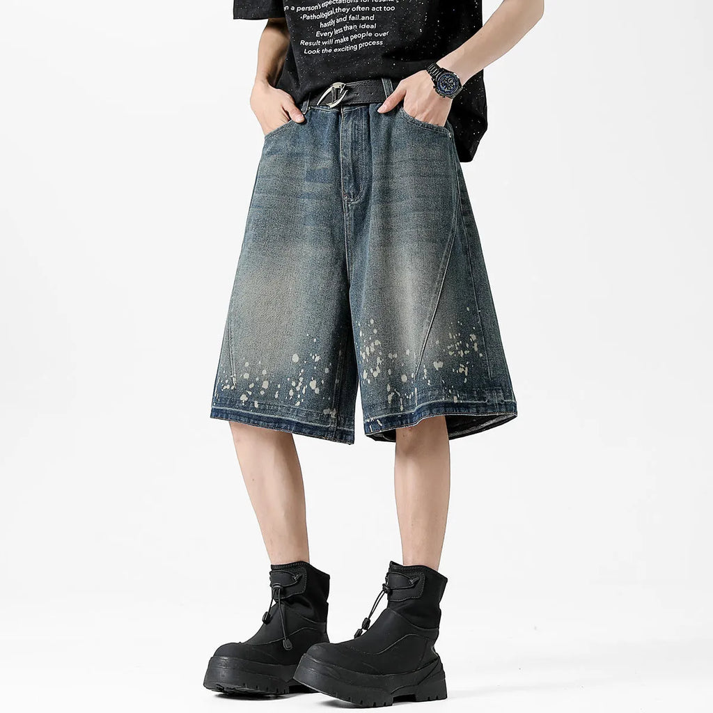 Retro blue denim shorts with distressed rip details and splash ink patterns, straight leg cut