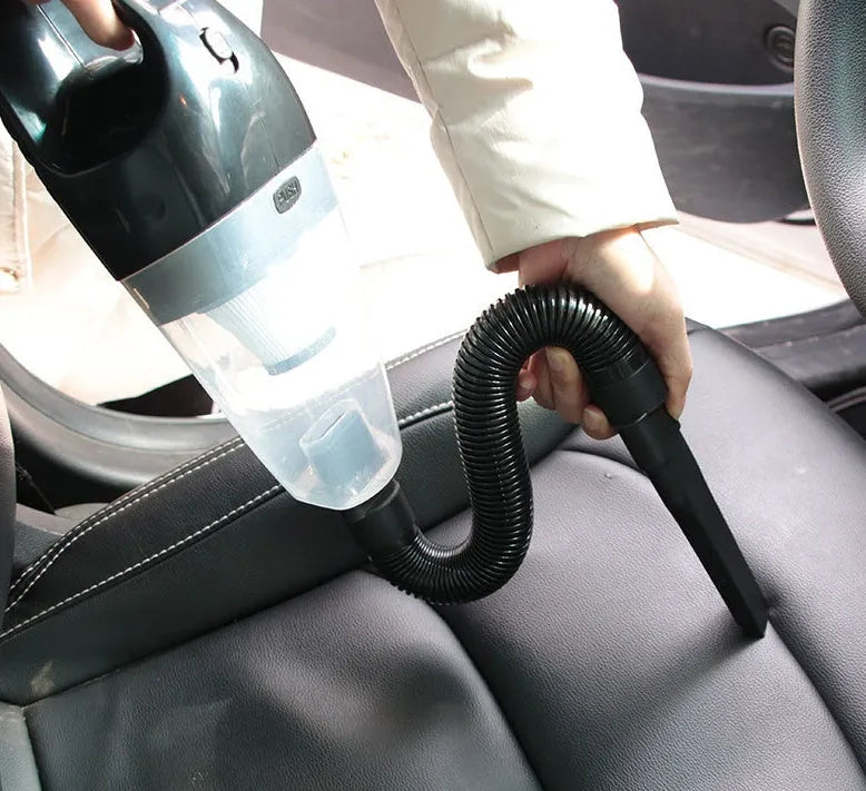 Orange handheld car vacuum cleaner with nozzle, 12V plug and cord for interior cleaning.