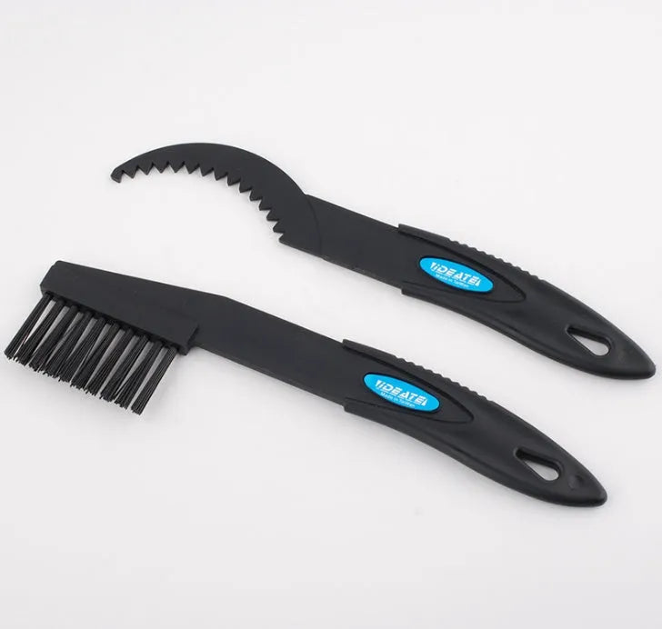 Blue plastic bicycle chain cleaning washer set with brushes on a bike chain