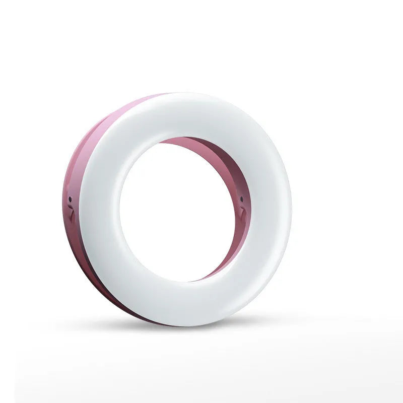 Compact black selfie ring light for mobile phone with USB cable for charging.