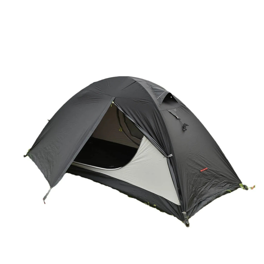 Black single person hiking tent with aluminium poles pitched outdoors, showing double-layer design.