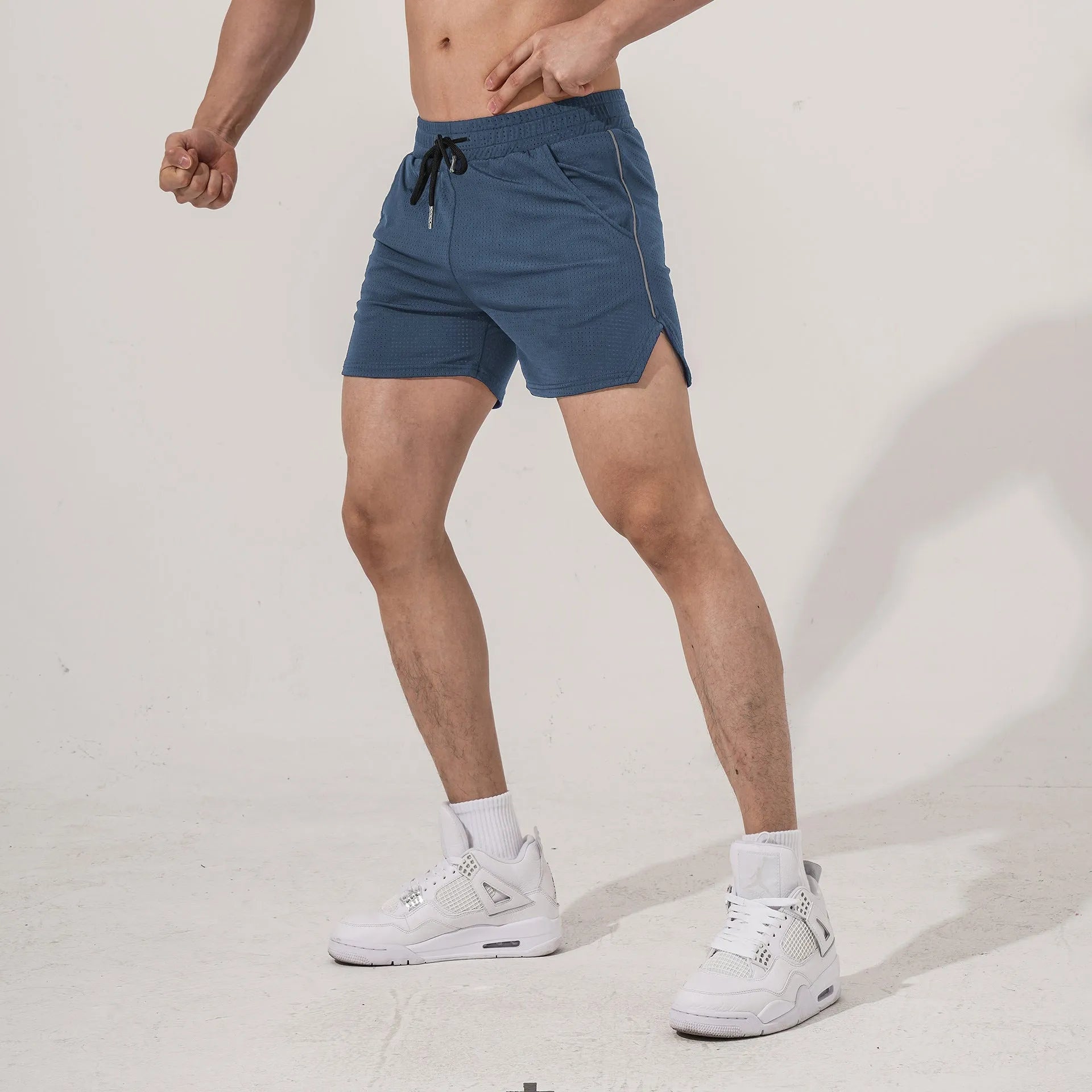 Men's black polyester straight-leg sports casual shorts on a neutral background.