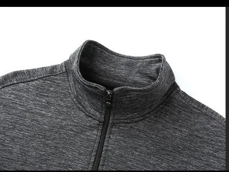 Man wearing a grey stand-up collar casual zip-front jacket with an athletic fit.