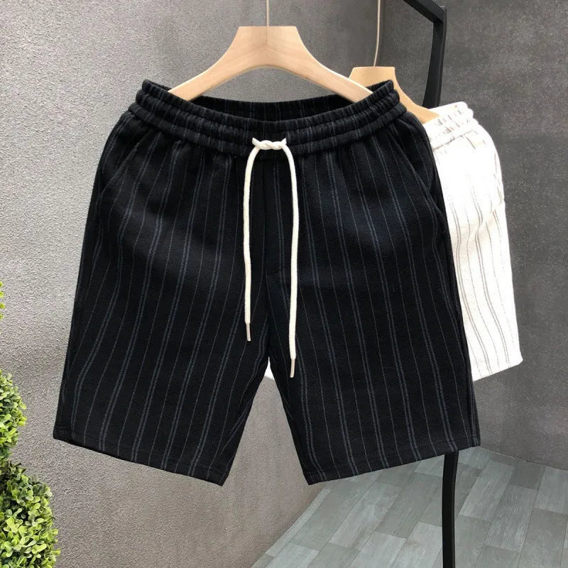 Man wearing black and white striped fleece-lined casual shorts with an elasticated waistband.