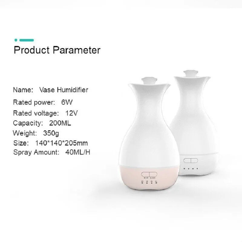 White or pink ultrasonic essential oil diffuser with water tank and multicolour LED night light on a table.