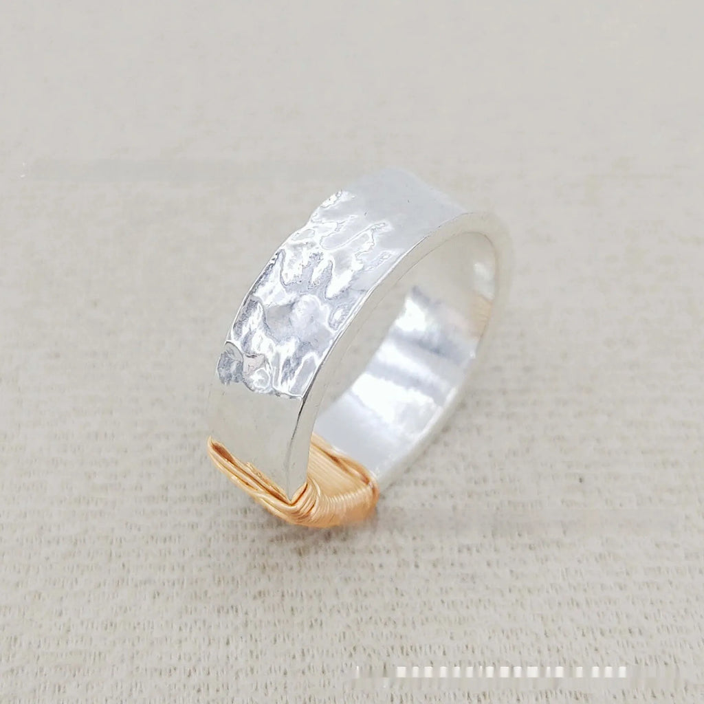 Simple geometric ring bracelet in electroplated copper with silver gold coil finish showing irregular coil design
