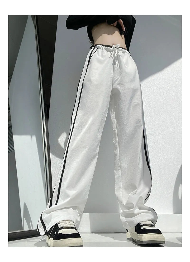 Navy blue and white loose straight leg trousers with ribbon parallel bars detail.