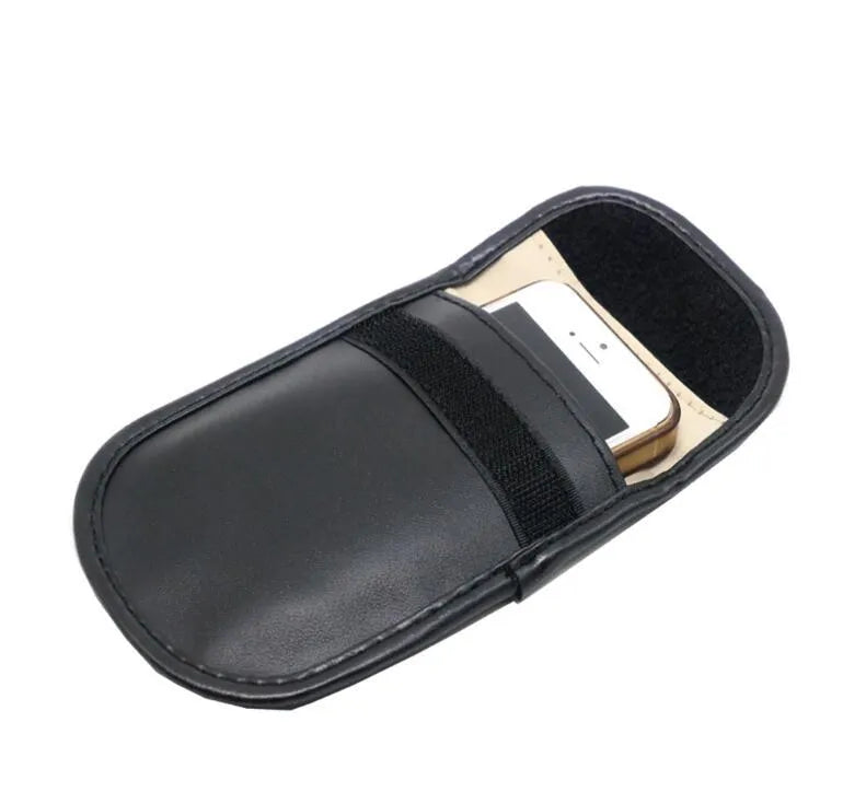 Black microfibre Faraday pouch for blocking car key, phone, and bank card signals, shown with a key fob inside.