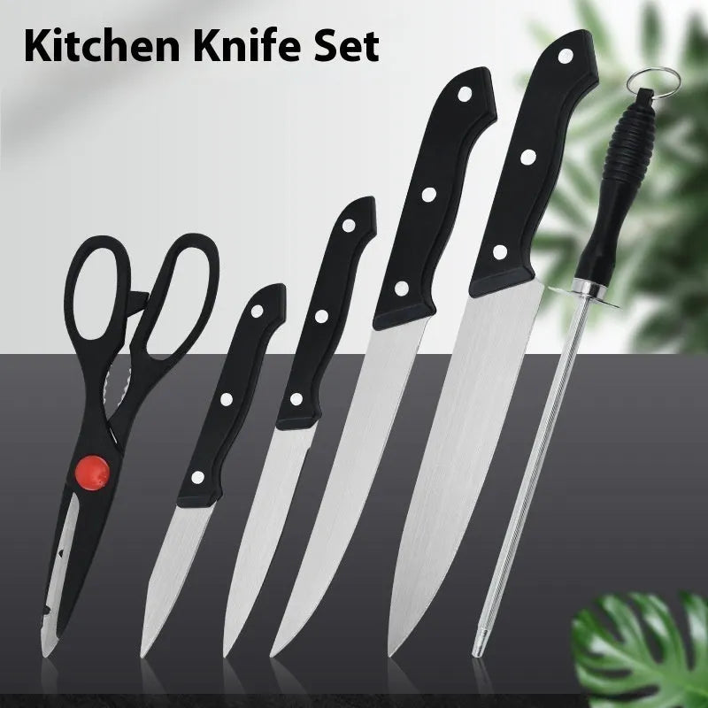 Stainless steel knife with 17.5cm blade and black A-style cutting board on kitchen countertop